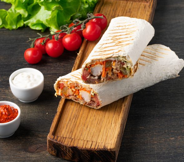Delicious shawarma sandwich on wooden background. Banner.